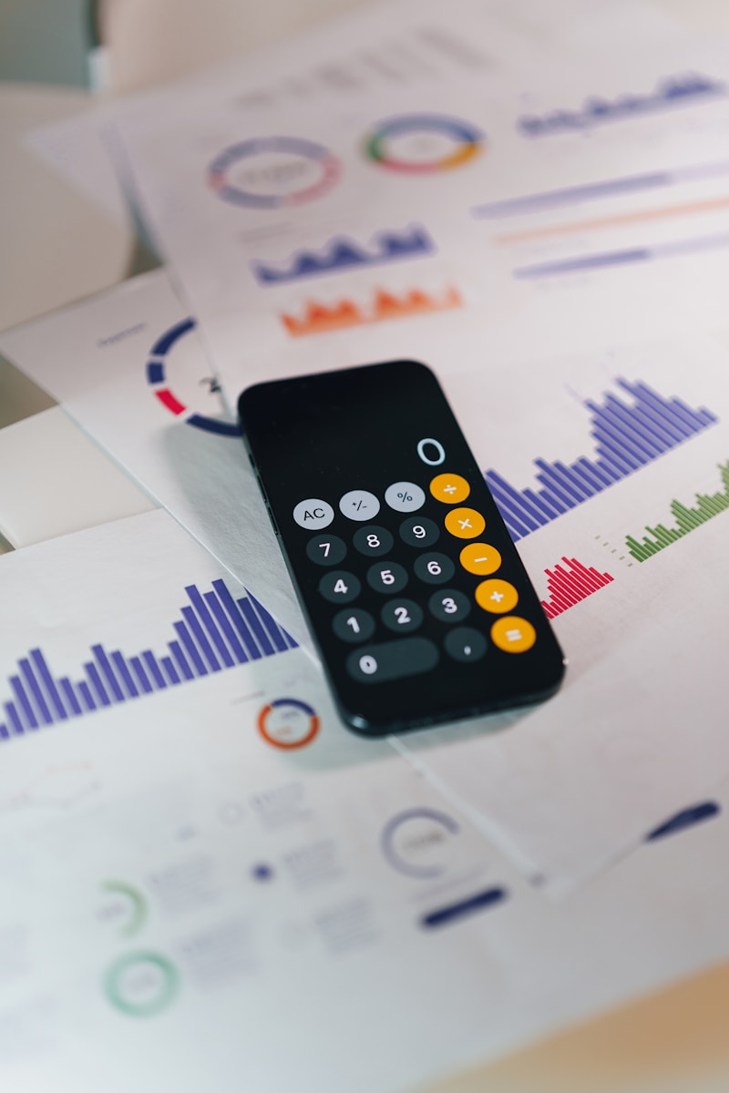 smartphone calculator app on financial report papers